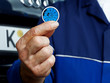 Close up of a hand with MOT certificate