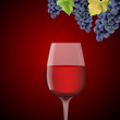 Glass with red wine and grapes