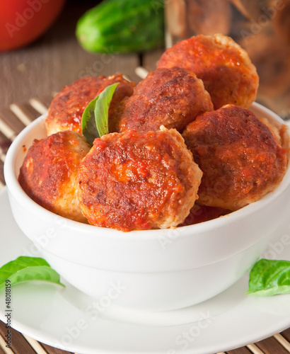 Photo: meatballs in tomato sauce, decorated with leaves of basil meatballs in tomato sauce, decorated with leaves of basil