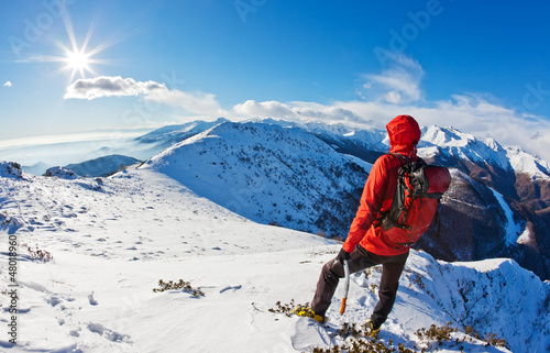 Photo: Mountaineer while observing a mountain panorama. Mountaineer while observing a mountain panorama.