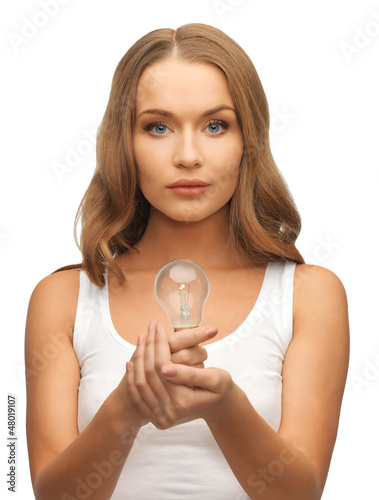 Photo: woman with energy saving bulb woman with energy saving bulb