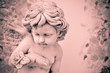 Vintage cupid sculpture with floral background