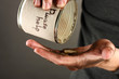 homeless pours money from bank, close-up