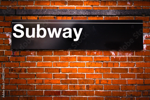 Photo: New York City subway sign entrance on brick wall New York City subway sign entrance on brick wall