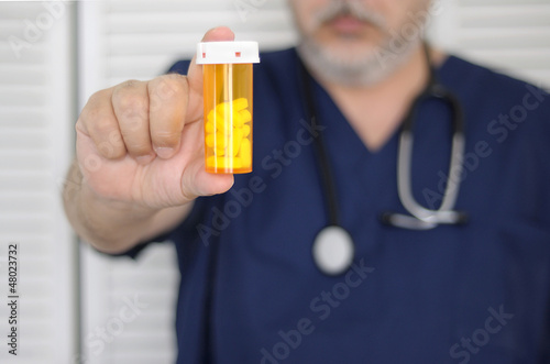 Photo: doctor with pill bottle doctor with pill bottle