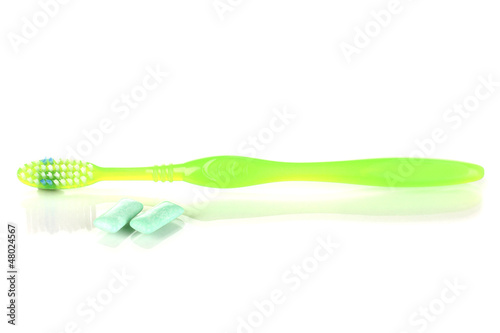 Photo: Toothbrush and chewing gum isolated on white Toothbrush and chewing gum isolated on white