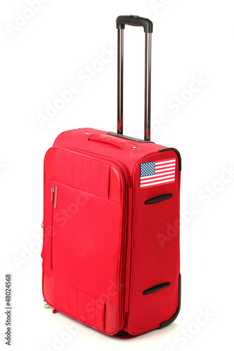 Photo: red suitcase with sticker with flag of USA isolated on white red suitcase with sticker with flag of USA isolated on white