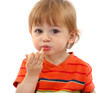 cute little boy eating tangerine, isolated on white