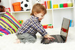 cute little boy and notebook in room