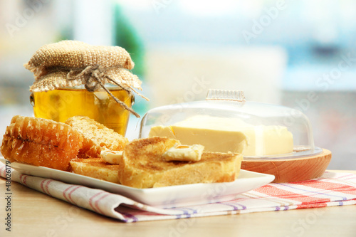 Photo: White bread toastwith honey on plate in cafe White bread toastwith honey on plate in cafe