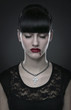 Beautiful gothic vampire woman portrait over dark background