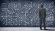 Business person against the blackboard