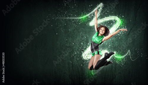 Photo: Young woman dancer. With lights effect. Young woman dancer. With lights effect.