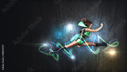 Photo: Young woman dancer. With lights effect. Young woman dancer. With lights effect.