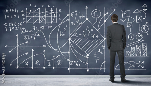 Photo: Business person against the blackboard Business person against the blackboard