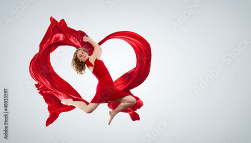 Photo: Dancing young woman with flying fabric Dancing young woman with flying fabric