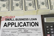 Approved small business loan application form and money