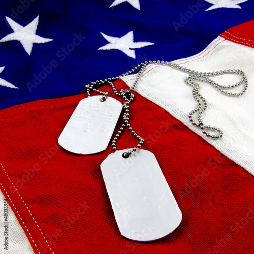 Photo: Military dog tags on vivid stars and stripes background Military dog tags on vivid stars and stripes background