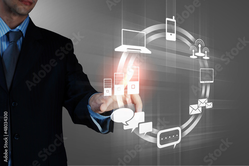 Photo: hand pushing on a touch screen hand pushing on a touch screen