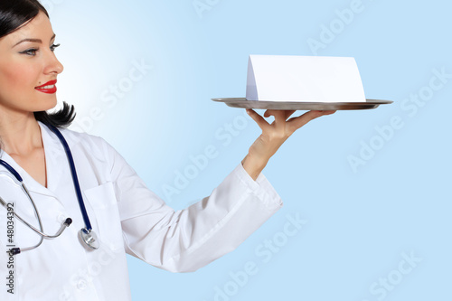 Photo: Young female doctor with a banner Young female doctor with a banner