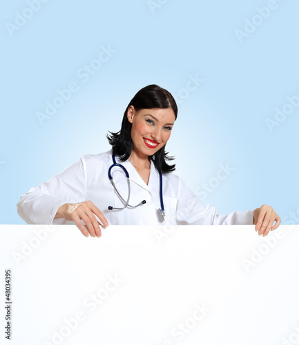 Photo: Young female doctor with a banner Young female doctor with a banner