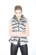 Trendy Woman in Fur Waistcoat and Leggings Posing in Studio