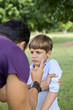Parenthood and children education, angry man scolding boy in par