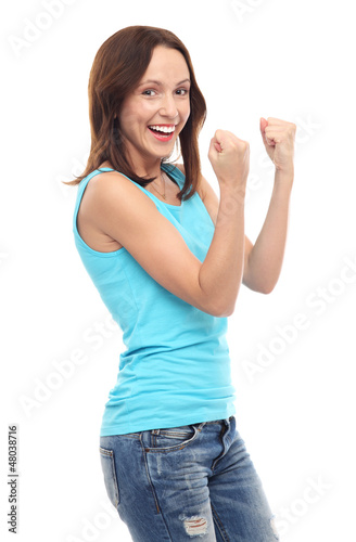Photo: Happy young woman clenching fists Happy young woman clenching fists
