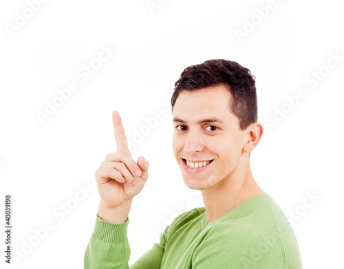 Photo: Portrait of happy young casual man pointing over white backgroun Portrait of happy young casual man pointing over white backgroun