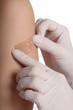 Putting a plaster over the wound