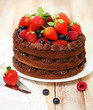 Chocolate cake with icing and fresh berry