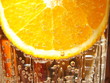 Orange slice in water with bubbles