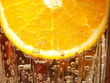 Orange slice in water with bubbles