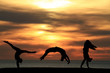 Photo: group of gymnasts tumbling in sunset group of gymnasts tumbling in sunset