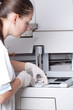 Woman loading samples in biochemical analyzer