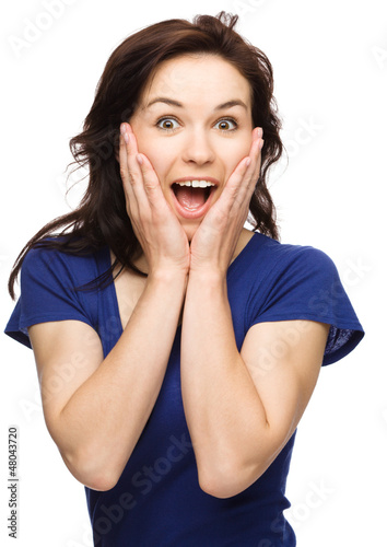 Photo: Woman is holding her face in astonishment Woman is holding her face in astonishment