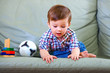 curious little baby boy on couch