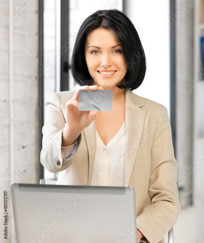 Photo: happy woman with laptop computer and credit card happy woman with laptop computer and credit card