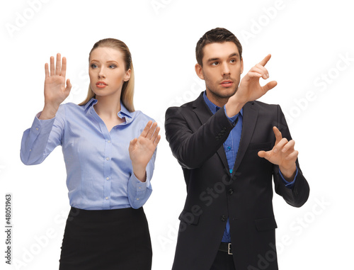 Photo: man and woman working with something imaginary man and woman working with something imaginary