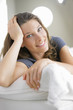 Portrait of a young woman smiling on white couch