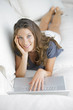 Sweet young lady on couch with laptop