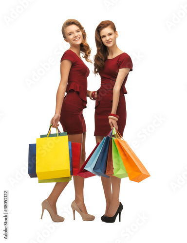 Photo: teenage girls in red dresses with shopping bags teenage girls in red dresses with shopping bags