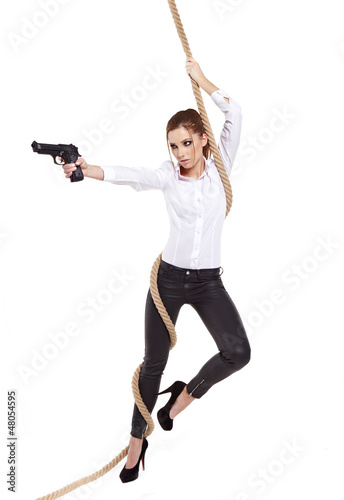 Photo: young beauty woman holding handgun, ready to fight young beauty woman holding handgun, ready to fight
