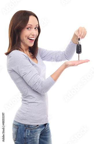 Photo: Young woman showing car key Young woman showing car key