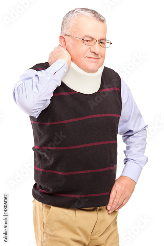 Photo: An injured mature man with neck holder suffering from a pain An injured mature man with neck holder suffering from a pain