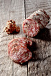 Photo: Pork and walnut salami on a wooden background Pork and walnut salami on a wooden background