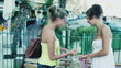 Happy young female friends walking with shopping bags in the cit
