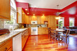 Red beautiful large kitchen with cherry hardwood.