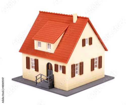 Photo: A model of house with red roof on a white background A model of house with red roof on a white background