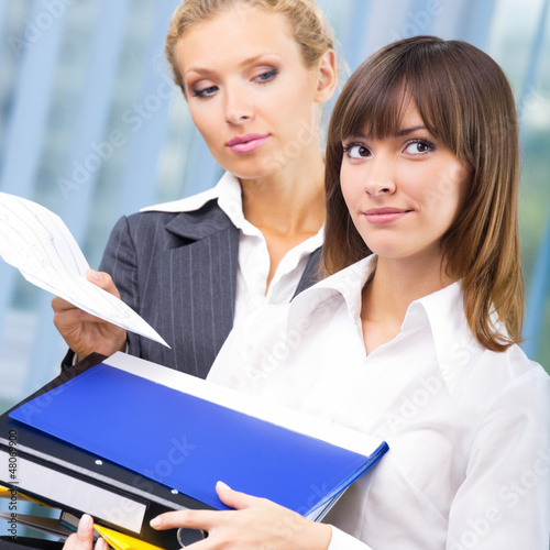 Photo: Businesswomen with documents at office Businesswomen with documents at office